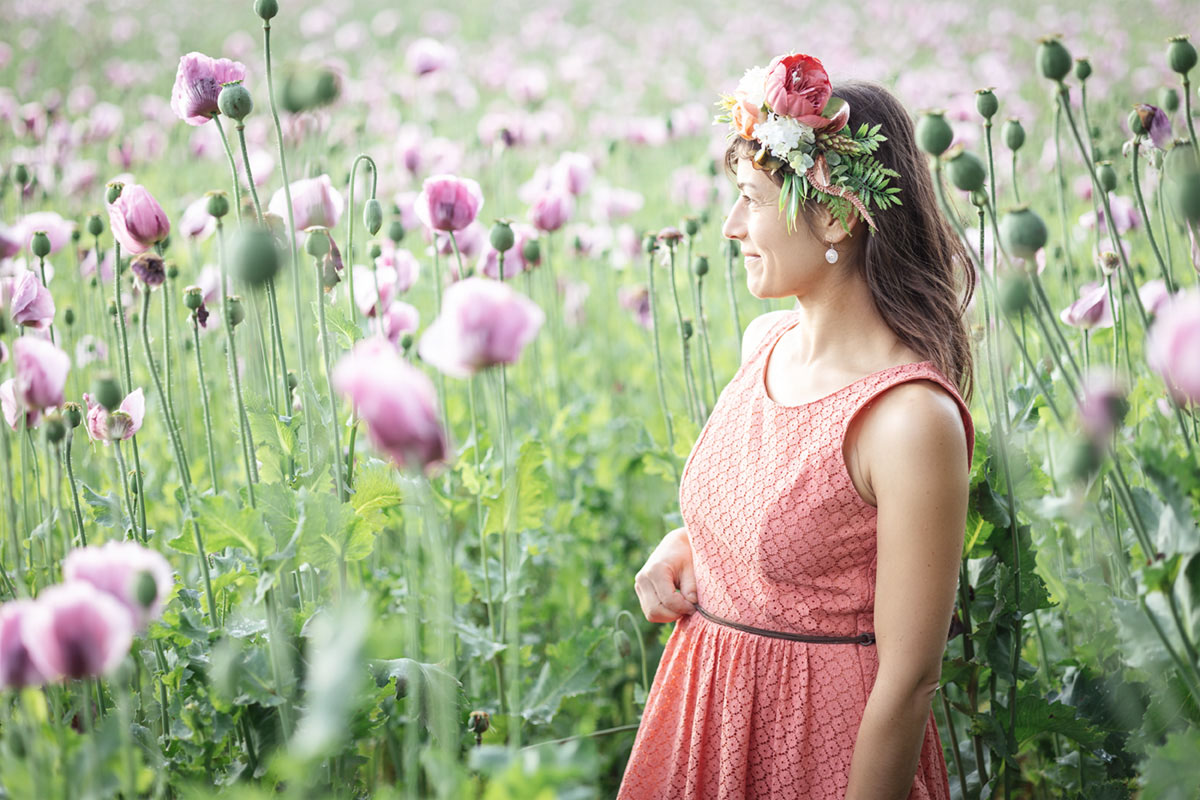 Frauenportrait im Seitenprofil im Mohnfeld Frauenportrait im Seitenprofil im Mohnblumenfeld